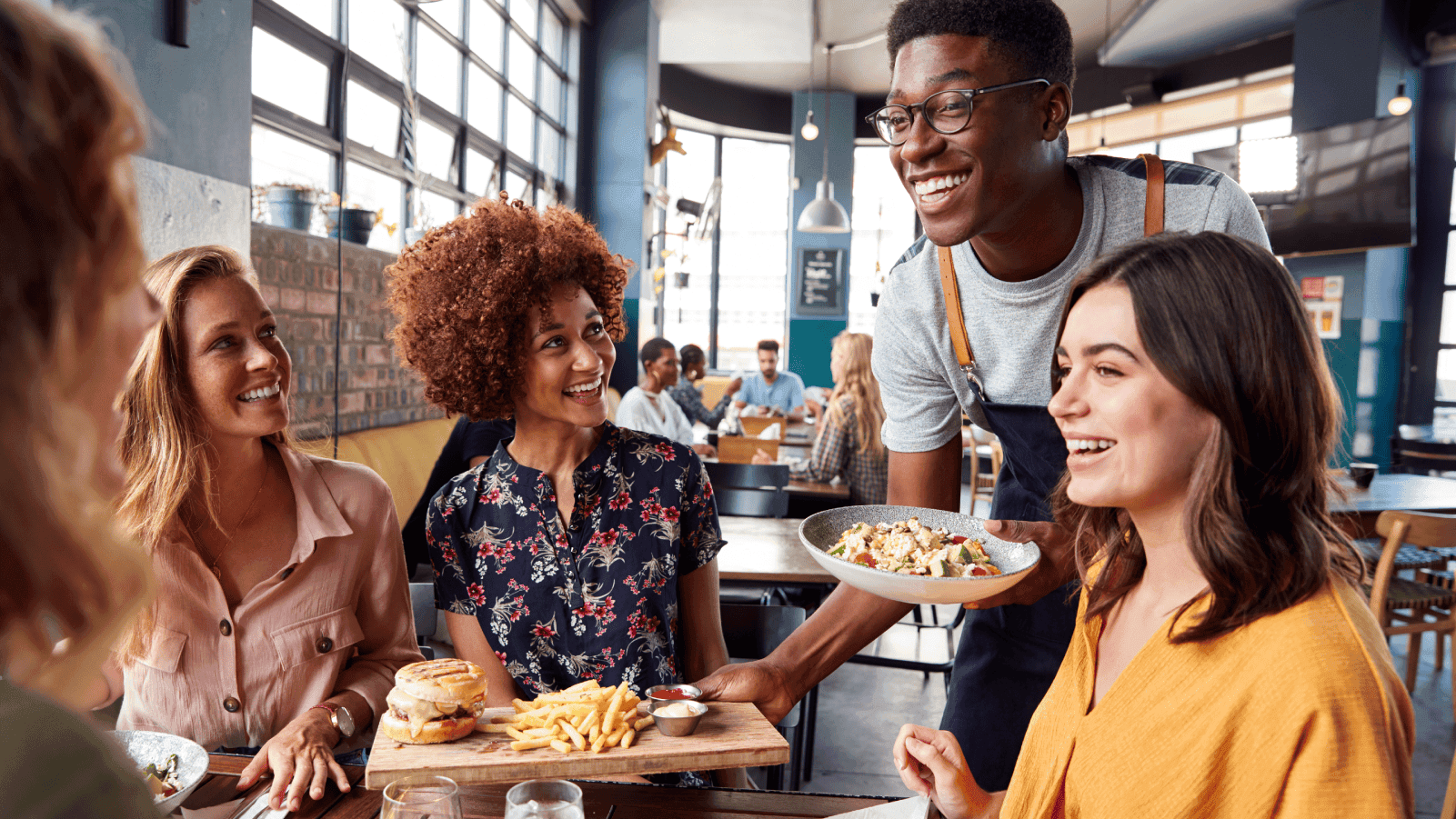 Restaurant guests enjoying a meal with their server